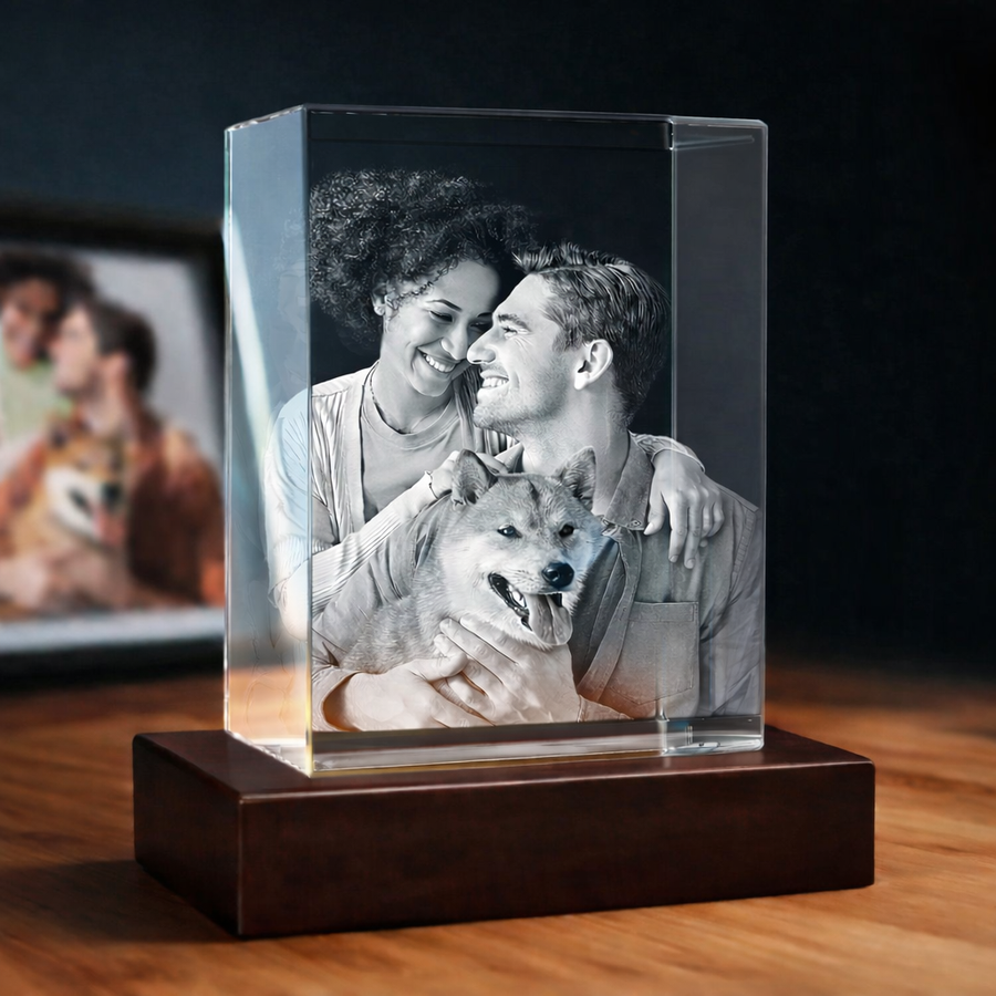 Personalized 3D crystal photo of a coaple holding her dog, displayed on a black LED light base