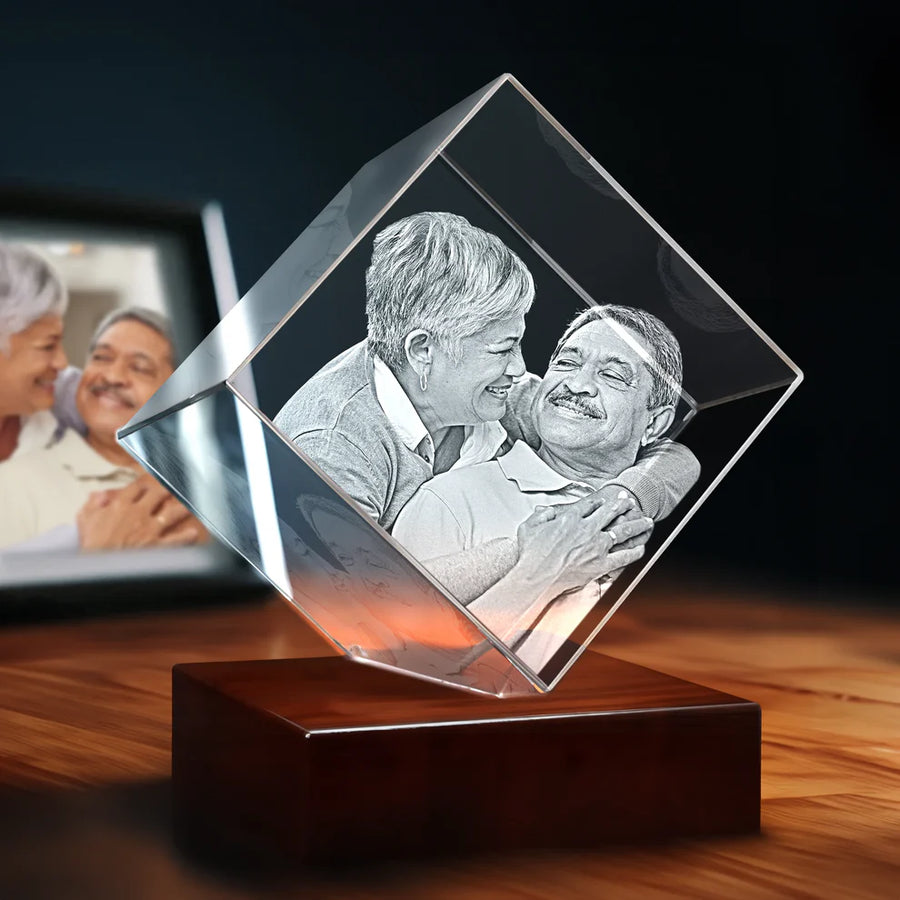 Cube-shaped 3D crystal photo featuring an engraved portrait, displayed on a wooden LED light base
